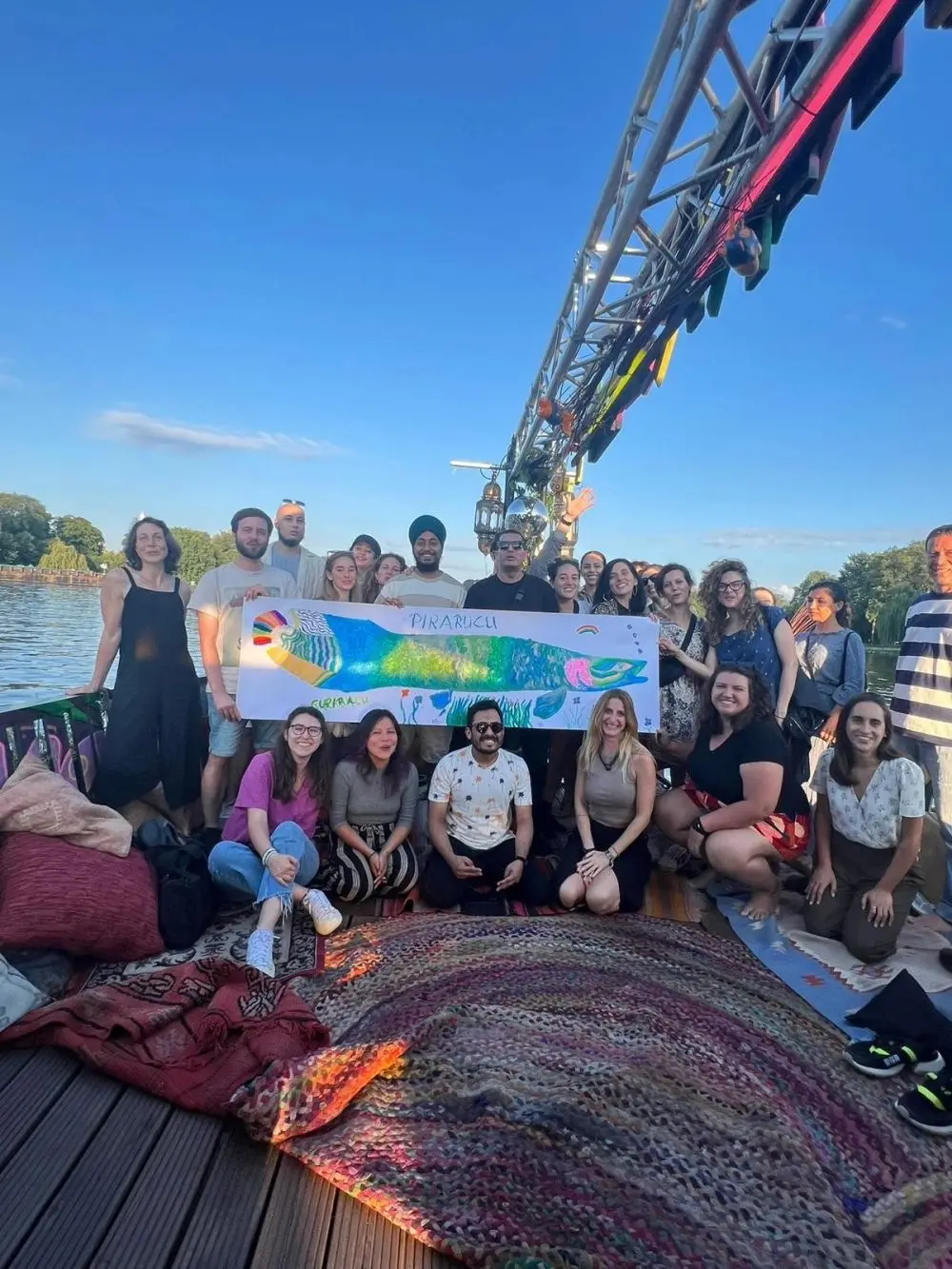 Ka'a Harmony community event in Berlin with a hand-painted pirarucu banner